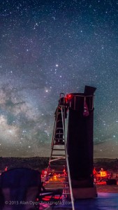 A deep-sky observer at the top of a tall ladder looking through a tall and large Dobsonian telescope, at the Texas Star Party, May 2015. Scorpius is rising in the background; Saturn is in the head of Scorpius as the bright star above centre. Anatares is just below Saturn. This is a single 30-second exposure at f/2.5 with the 24mm lens and Canon 5D MkII at ISO 6400.