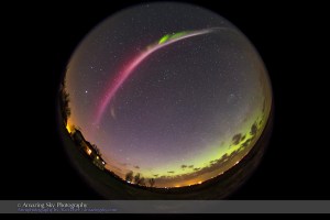 A strange red/magenta auroral arc overhead across the sky, with a more normal green diffuse glow to the north, as seen on May 10, 2015. The Big Dipper is overhead in the centre of the frame, Jupiter is at left in the west and Arcturus is at top to the south. I shot this from home, using an 8mm fish-eye lens to take in most of the sky, with the camera looking north. It is part of a 170-frame time-lapse sequence. Exposure was 32 seconds at f/3.6 and ISO 3200 with the Canon 6D.