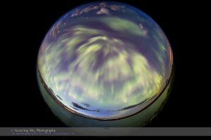 The all-sky aurora of June 22, 2015, during a level 7 to 9 geomagnetic storm, as the display brightened again in the middle of the night at about 1 am, with rays converging at the zenith in the perpetual twilight of a solstice night. This is one frame from a 568-frame time-lapse, taken with the 8mm Sigma fish-eye lens at f/3.5 and with the Canon 6D, composed for projection in tilt-dome digital planetariums. I was on the south shore of Crawling Valley Lake and Reservoir in southern Alberta.