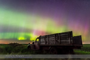 An aurora display on the night of June 7/8, 2015 from southern Alberta, with an old rustic farm truck as the foreground. This is a frame from a 450-frame time-lapse with the Nikon D740 at ISO 1600 and the Sigma 24mm lens at f/2.8, for 8 second each. The foreground is from a stack of 8 images adjacent in time to the sky image stacked in Mean mode for smoothing of noise.