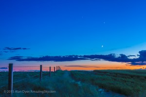 The waxing crescent Moon below Venus and fainter Jupiter above, with the three worlds forming a triangle in the twilight, on the evening of June 19, 2015, from a site north of Bassano, Alberta. This is an HDR stack of 5 exposures to retain detail in the dark foreground and bright twilight sky. This is with the 50mm lens and Canon 6D.