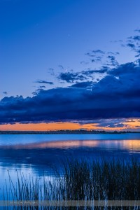 The waxing crescent Moon below Venus and dimmer Jupiter above, all over Crawling Lake Reservoir, in southern Alberta, on June 19, 2015. This is a 5-exposure HDR stack to preserve deatails in the dark foreground and bright sky. Shortly after I took this shot clouds from an approaching storm front obscured the planets and the sky.