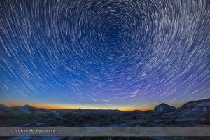 Summer solstice twilight and circumpolar star trails over the badlands of Dinosaur Provincial Park, Alberta. Some bright noctilucent clouds are visible low on the northern horizon. I shot this June 15, 2015 as part of a shoot for a “star trail” video tutorial, as an example image. This is a stack of the first 200 frames of 275 shot for a time-lapse, each 15 seconds at f/2.8 with the Rokinon 14mm lens and Canon 6D at ISO 1600. I stacked them in Advanced Stacker Actions with the ultrastreak mode. The foreground comes from a mean blend of the first 8 frames, to smooth noise, and to provide a brighter foreground from early in the sequence when the sky and ground were brighter.