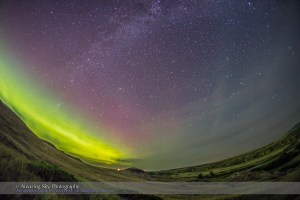An aurora display to the northeast over the Milk River Valley and Writing-on-Stone Provincial Park in southern Alberta, night of July 22/23, 2015. The ground is lit by aurora light. The view is looking east to the rising autumn constellations of Cassiopeia and Perseus at left, and Andromeda and Pegasus at centre. The Milky Way runs from left to top centre. I shot this with the 15mm full-frame fisheye and Canon 6D. The sky is from one image, but the ground is from a stack of 4 images, mean combined, to smooth noise.