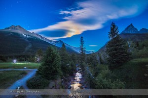 A nightscape photographer from one of my workshops, shooting in the moonlight at Red Rock Canyon, in Waterton Lakes National Park, Alberta. Clouds partly obscure the gibbous Moon but add a colourful iridescent corona around the Moon, which is reflected in the Red Rock Canyon Creek. This is an HDR stack of 5 exposures with the 14mm lens and Canon 6D, to preserve detail in the bright clouds and the disk of the Moon, and in the dark shadows.