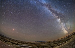 The Moon in total eclipse on September 27, 2015 – the “supermoon” eclipse – shining red over the Milk River and sandstone formations at Writing-on-Stone Provincial Park in southern Alberta, with the Milky Way in full view in the sky darkened by the lunar eclipse. The Sweetgrass Hills of Montana are to the south. The centre of the Milky Way is at far right. The Andromeda Galaxy is at upper left. The Moon was in Pisces below the Square of Pegasus. It was a perfectly clear night, ideal conditions for shooting the eclipse and stars. This is a stack of 5 x 2-minute tracked exposures for the sky and 5 x 4-minute untracked exposures for the ground to smooth noise. The Moon itself comes from a short 30-second exposure to avoid overexposing the lunar disk. Illumination of the ground is from starlight. All exposures with the 15mm lens at f/2.8 and Canon 5D MkII at ISO 1600. The camera was on the iOptron Sky-Tracker.