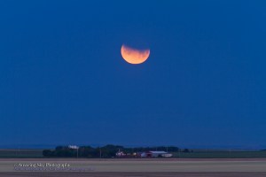 Partial eclipse of the Moon at moonset, morning of June 26, 2010, at about 5:00 am. Shot with 200mm telephoto and 1.4x teleconvertor, for 1/15th sec at f/5 and ISO 100, using Canon 7D.
