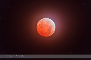 The total eclipse of the Moon, October 8, 2014, the Hunter’s Moon, as seen and shot from Writing-on-Stone Provincial Park, Alberta under mostly clear though slightly hazy skies, thus the glow around the Moon. The planet Uranus is the brightest dot left of the Moon at 8 o’clock position. Both the Moon and Uranus were at opposition. This was the second in a “tetrad” series of 4 total lunar eclipses in a row at six-month intervals in 2014 and 2015. I shot thus just after mid-totality though with the northern limb of the Moon still bright in this single 15-second exposure at ISO 400 with the Canon 60Da, and with the Officina Stellaire 80mm apo refractor at f/6. It was mounted on the Sky-Watcher HEQ5 mount tracking at the lunar rate. I chased into clear skies to see and shoot this eclipse.