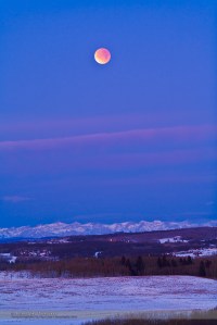 This is the total eclipse of the Moon, December 10, 2011, taken from the grounds of the Rothney Astrophysical Observatory, near Priddis Alberta, and looking west to the Rockies. This is a 2 second exposure at ISO 800 with the Canon 5DMkII and Canon 200mm lens at f/4. This was taken toward the end of totality at 7:48 am local time.