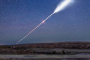 This is a multiple-exposure composite of the total lunar eclipse of Sunday, September 27, 2015, as shot from Writing-on-Stone Provincial Park, Alberta, Canada. From this location the Moon rose in the east at lower left already in partial eclipse. As it rose it moved into Earth’s shadow and became more red and the sky darkened from twilight to night, bringing out the stars. Then, as the Moon continued to rise higher it emerged from the shadow, at upper right, and returned to being a brilliant Moon again, here overexposed and now illuminating the landscape with moonlight. The disks of the Moon become overexposed here as the sky darkened because I was setting exposures to show the sky and landscape well, not just the Moon itself. That’s because I shot the frames used to assemble this multiple-exposure still image primarily for use as a time-lapse movie where I wanted the entire scene well exposed in each frame. Indeed, for this still image composite of the eclipse from beginning to end, I selected just 40 frames taken at 5-minute intervals, out of 530 I shot in total, taken at 15- to 30-second intervals for the full time-lapse sequence. All were taken with a fixed camera, a Canon 6D, with a 35mm lens, to nicely frame the entire path of the Moon, from moonrise at left, until it left the frame at top right, as the partial eclipse was ending. The ground comes from a blend of 3 frames taken at the beginning, middle and end of the sequence, so is partly lit by twilight, moonlight and starlight. Lights at lower left are from the Park’s campground. The sky comes from a blend of 2 exposures: one from the middle of the eclipse when the sky was darkest and one from the end of the eclipse when the sky was now deep blue. The stars come from the mid-eclipse frame, a 30-second exposure. PLEASE NOTE: The size of the Moon and its path across the sky are accurate here, because all the images for this composite were taken with the same lens using a camera that did not m