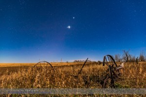 The planet trio of Venus (brightest), Jupiter (above Venus) and Mars (dim and red to the left of Venus), all in Leo in the morning sky on November 1, 2015, with the waning gibbous Moon illuminating the landscape and sky. Even in the moonlight, the Zodiacal Light seems to be faintly visible along the ecliptic defined by the line of planets.  This is a stack of 6 x 30-second exposures at f/5.6 and ISO 2500 for more depth of the field for the ground, plus a 13-second exposure at f/2.5 and ISO 800 to minimize star trailing. The ground exposures were mean combined in a stack to smooth noise. Diffraction spikes added with Astronomy Tools Actions for Photoshop.