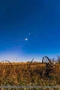 The planet trio of Venus (brightest), Jupiter (above Venus) and Mars (dim and red to the left of Venus), all in Leo in the morning sky on November 1, 2015, with the waning gibbous Moon illuminating the landscape and sky. The stars of Leo, including Regulus, shine above the planets. This is a stack of 4 x 30-second exposures at f/5.6 and ISO 2000 for more depth of the field for the ground, plus a 10-second exposure at f/2.8 and ISO 2000 to minimize star trailing. The ground exposures were mean combined in a stack to smooth noise. Diffraction spikes added with Astronomy Tools Actions for Photoshop.