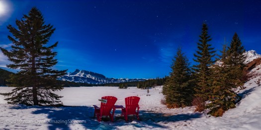 Parks Canada Red Chairs under the Winter Sky at Two Jack Lake
